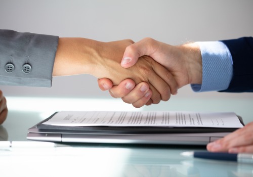 Closing Attorneys in Morton IL shaking hands over a real estate agreement