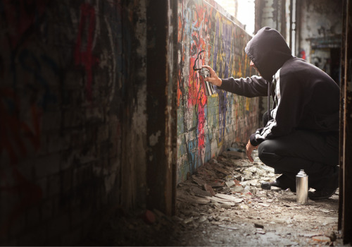 A teenager defacing a wall and violating Juvenile Law in Peoria IL